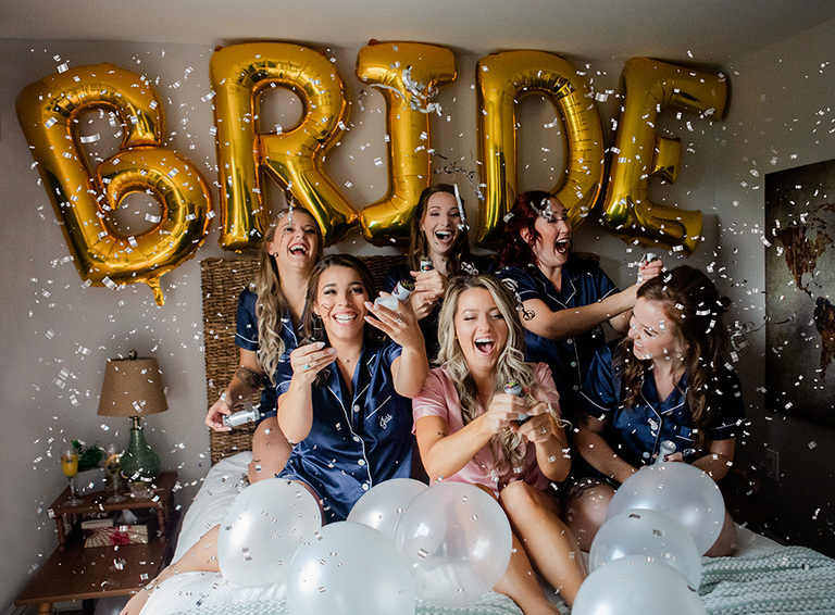 bridal party on morning of wedding toasting the bride