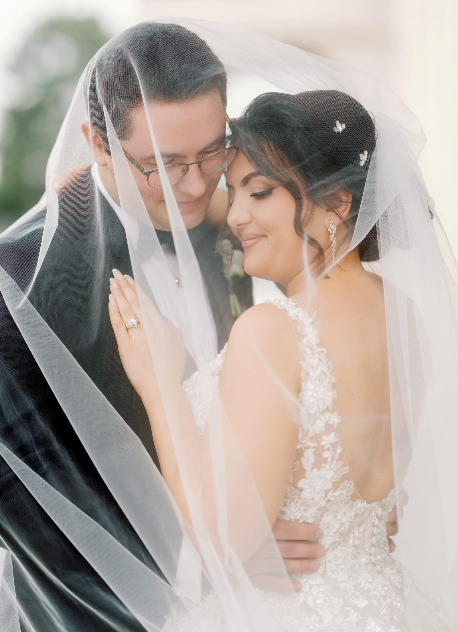 bride and groom underneath brides veil